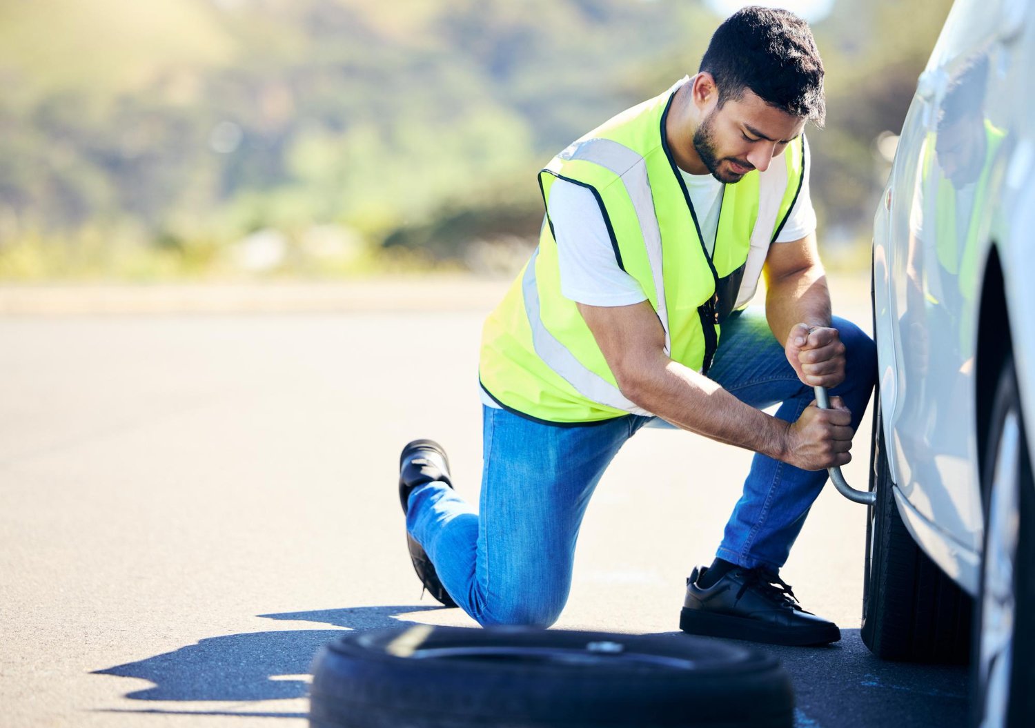 ROAM technician tightening a wheel roadside